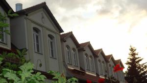 a row of houses with a red flag on them at Pension Kchischowka in Vetschau