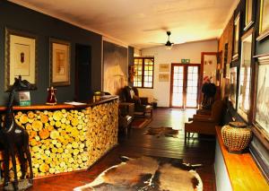 a living room with a fireplace and a living room with a fire place at The Wakkerstroom Hotel in Wakkerstroom