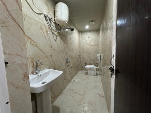 a bathroom with a sink and a toilet at Lari Guest House in Gorakhpur