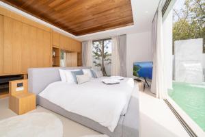 a bedroom with a large bed and a television at Sofia Villa Phuket in Phuket Town +52 photos