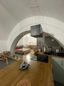 a kitchen with an archway and a living room at Archome Luxury Apartment in Brindisi