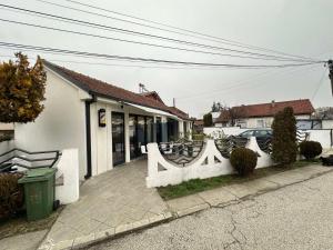 a white fence in front of a house at Skopje Home 19 in Skopje