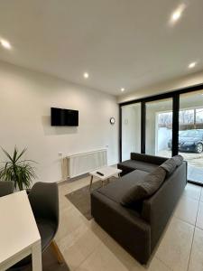 a living room with a couch and a tv on the wall at Skopje Home 19 in Skopje +11 photos