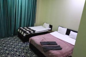 Postel nebo postele na pokoji v ubytování Ekm Hotel