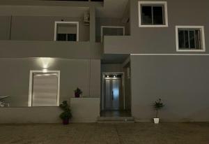 a building with a hallway leading to a door at Xhefri's Apartments in Vlorë