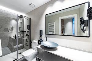 a bathroom with a sink and a toilet and a shower at Apartamentos París Boutique Valladolid in Valladolid +54 photos