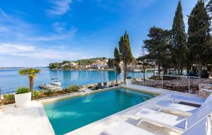 a swimming pool with a view of the water at Beautiful Villa Zman near sea in Dugi Otok in Žman