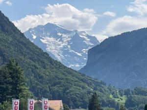 a view of a snow covered mountain in a valley at Q Lodge 103 in Matten