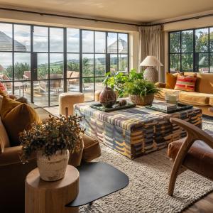 a living room with a couch and a table at Louma Country Hotel in Wootton Fitzpaine