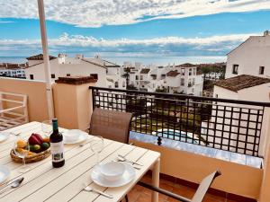 a table with a bowl of fruit on a balcony at Duquesa Regent 2435 Wonderful seaviews duplex in Manilva