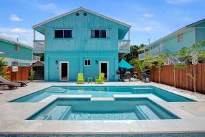 a house with a swimming pool in front of a house at Key Largo Home with Spa and Pool in Key Largo +22 photos