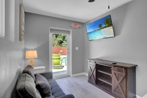 un soggiorno con divano e TV a schermo piatto di Key Largo Home with Spa and Pool a Key Largo