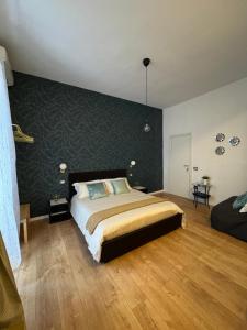 a bedroom with a bed and a green wall at La città di Pulcinella in Naples