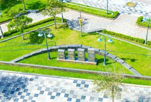 an overhead view of a park with a bench and lights at Sand Sea Hotel Phan Thiết in Phan Thiet