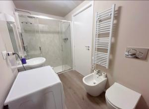 a white bathroom with a toilet and a sink at B&B Pizza Room Twin Room near Navigli Milan in Milan