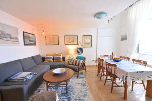 a living room with a couch and a table at Beach House Ischia - Seafront & Aragonese Castle View - in Ischia Town