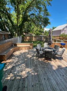 a wooden deck with a table and chairs and a bench at Seaside Creole Cottage in Gulfport