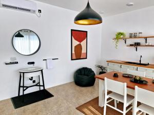 a kitchen and dining room with a table and chairs at White Nest in Unawatuna