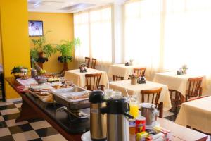 a restaurant with a table with food on it at Premier Palace Hotel in Araranguá