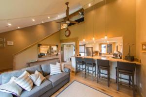 a living room and kitchen with a couch and a bar at Sky Is The Limit Centrally Located For Big Sky Fun in Big Sky