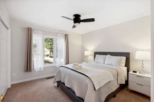 a white bedroom with a bed and a ceiling fan at Hialeah Hole in One Golf House in Pinehurst