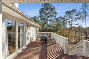 a deck with a table and chairs on a house at Hialeah Hole in One Golf House in Pinehurst