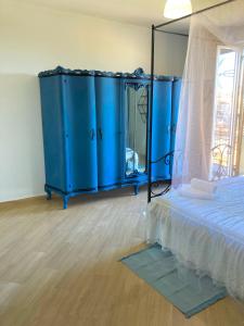 a bedroom with a blue bed and a mirror at Indipendenza Guest House in Palermo