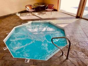 a hot tub in a room with chairs and a table at Big Sky Bungalow in Big Sky