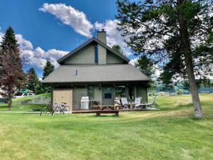 a house with a picnic table in front of it at Big Sky Bungalow in Big Sky