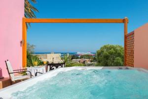 a hot tub on the balcony of a house at Nikos Takis Boutique Fashion hotel in Rhodes Town
