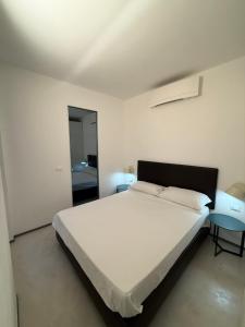 a bedroom with a large white bed and two tables at Mare Calmo 2 in Manarola