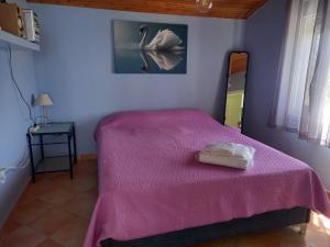 a bedroom with a bed with a pink blanket at Beach house in Nea Potidaea