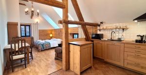 a kitchen with a bed and a table in a room at Jesionówka Apartamenty in Goworów