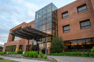 an office building with a glass facade at Neper Hotel in Cordoba