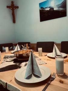 a wooden table with plates and a bowl of food at Alpenchalet Lengau in Dornauberg
