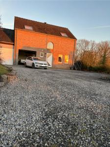 a car parked in front of a brick building at Au Charme de Durbuy in Durbuy +10 photos