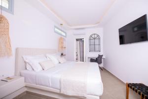A bed or beds in a room at SN Santorini Apartments