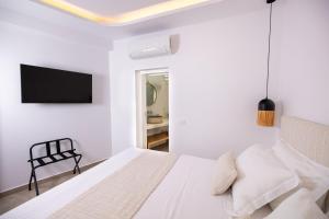 A bed or beds in a room at SN Santorini Apartments