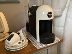 a coffee maker sitting on a counter next to dishes at Old Hall Croft Barn in Skipton