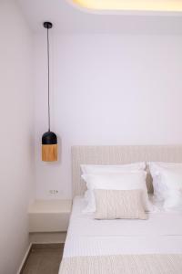 A bed or beds in a room at SN Santorini Apartments