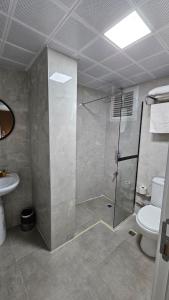 a bathroom with a shower and a toilet at Sever Hotel in Antalya