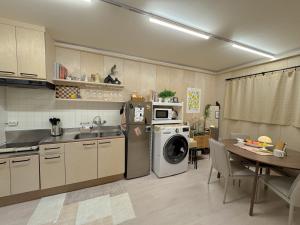 a kitchen with a washing machine and a dining room at Doors Seongsu in Seoul +42 photos