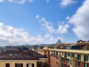 a view of a city with buildings and a cloudy sky at Vatican Charm Retreat in Rome