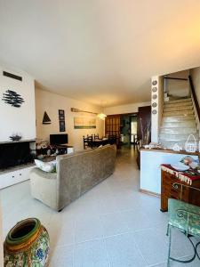 a living room with a couch and a staircase at Villetta Alberto in Viareggio