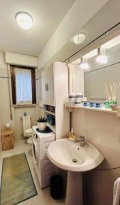 a white bathroom with a sink and a sink at Villetta Alberto in Viareggio +36 photos