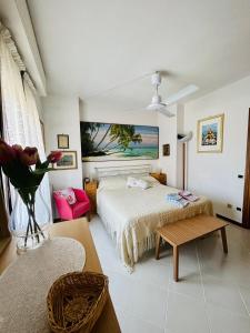 a bedroom with a bed and a vase of flowers at Villetta Alberto in Viareggio