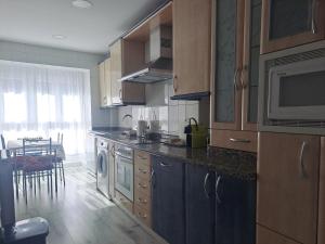 A kitchen or kitchenette at Apartamentos El Conde