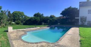 a swimming pool in the yard of a house at Three On Bond in Grahamstown
