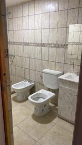 a bathroom with a toilet and a sink at Amalia Apart in San Rafael