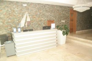 a reception desk in a lobby with a potted plant at Vista Marina Residence in Boca Chica +169 photos